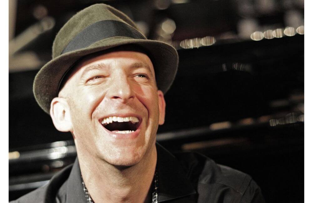Gary Negbaur grinning in a fedora