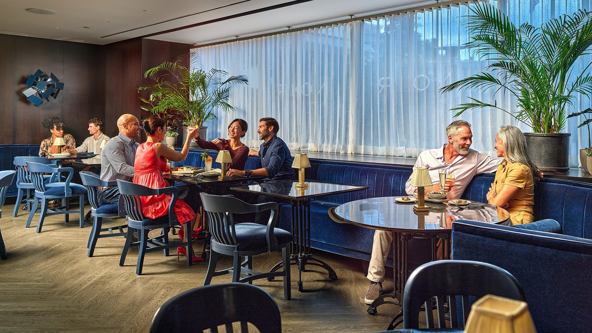 People gathered at tables at Noir
