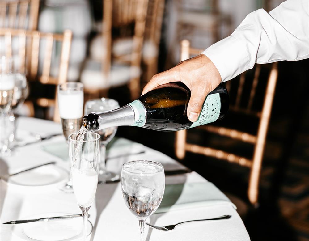 Champagne being poured into glasses by a staff member