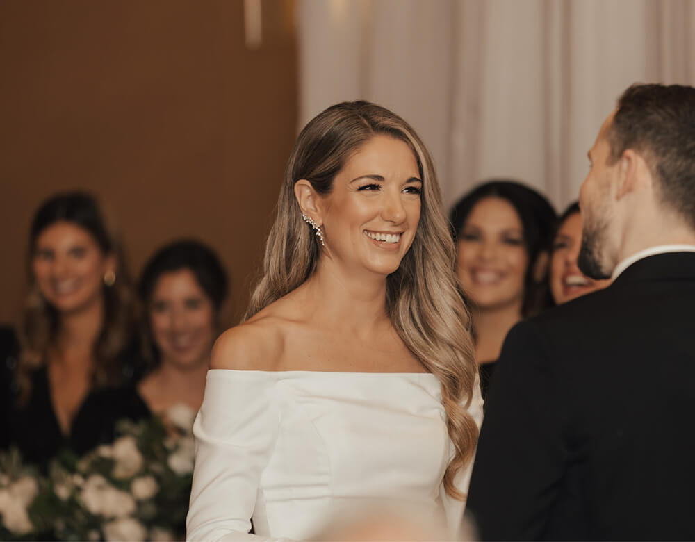 Wedding couple smiling together at the end of the aisle