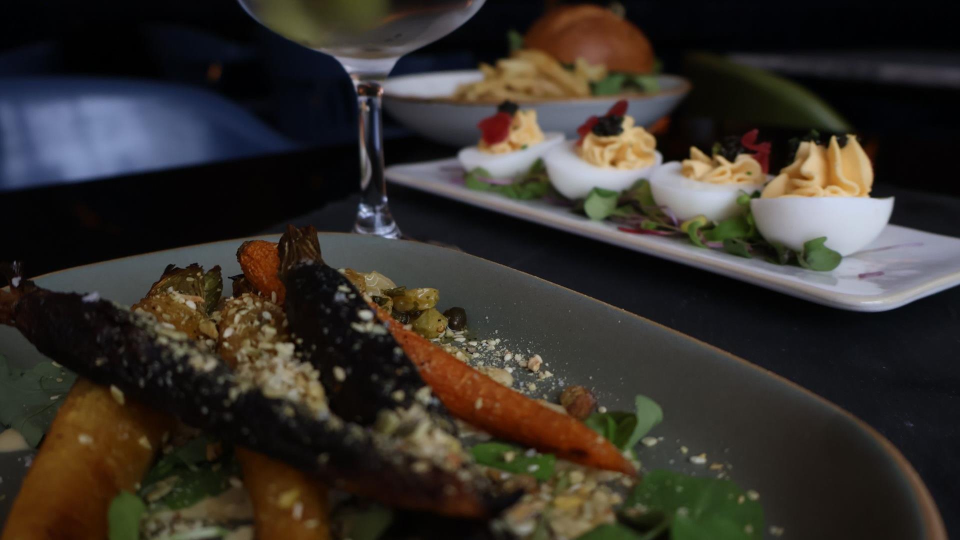 Noir carrots deviled eggs burger in background