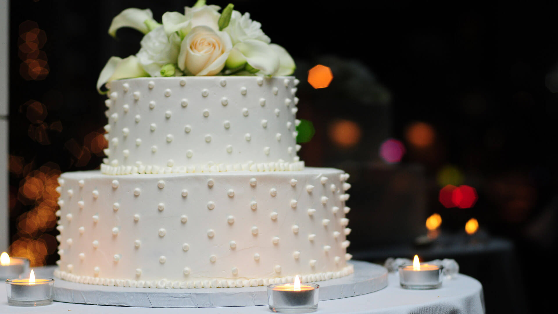 White cake with dots and flowers on top