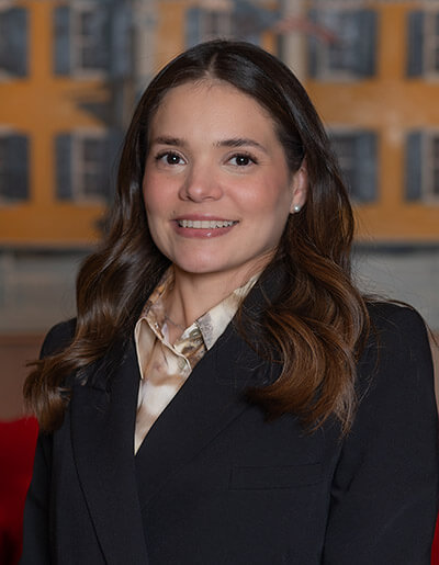 Alicia Quiroz in a black suit jacket and a beige dress shirt