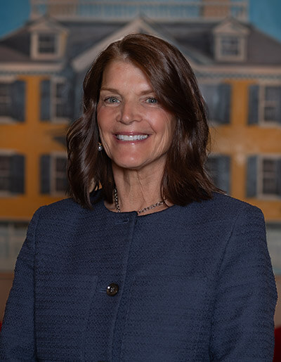 Debra Walsh in a navy blue jacket with black buttons