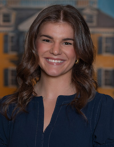 Kate Smiley in navy blue dress with contrast stitching