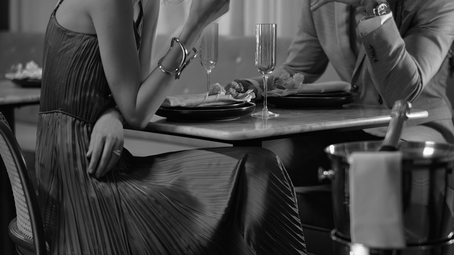 A black and white photo of a couple dining