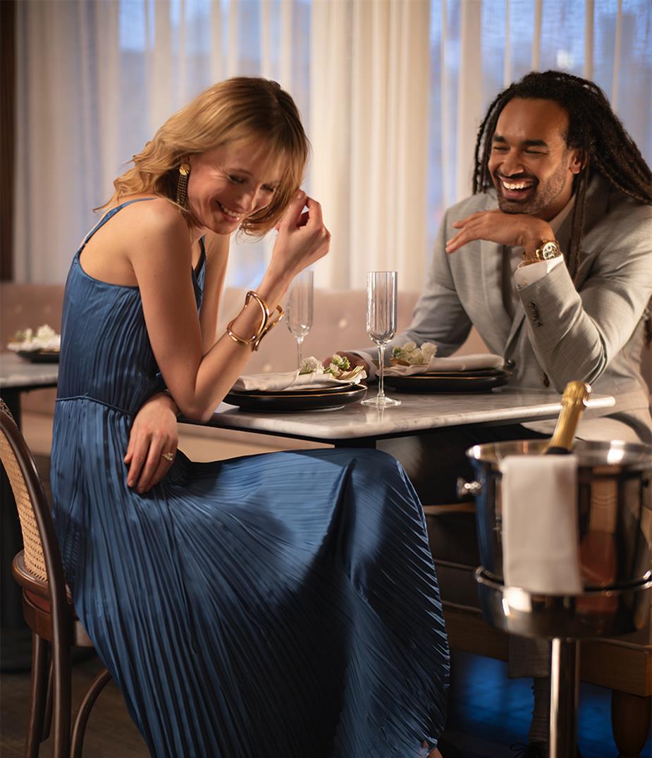 A couple laughing at a table