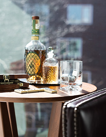 A table with alcohol on top and a cigar box