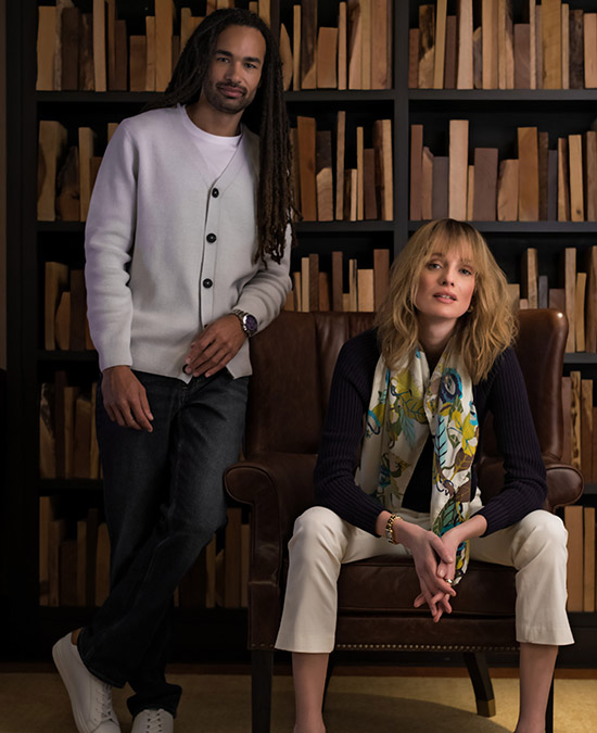 man and woman hanging out at lounge area by books 